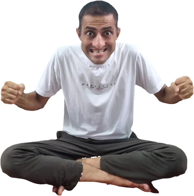 Sohan seated cross-legged with clenched fists and a strained, fierce expression
