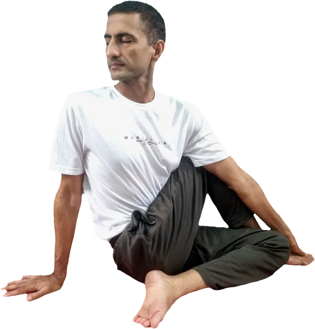 Sohan in a seated spinal twist, eyes closed, calm