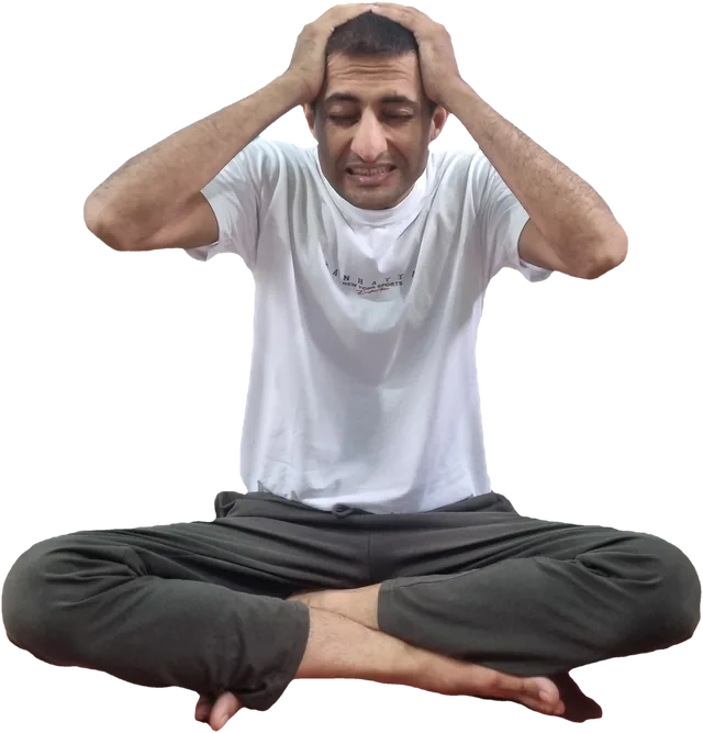 Sohan holding his head in both hands, tense