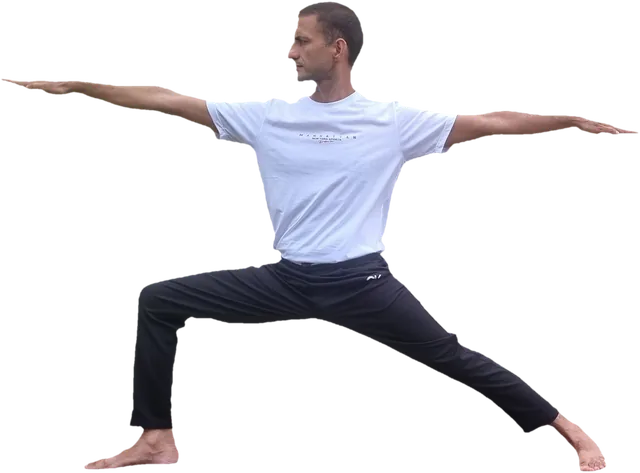 Sohan in a wide-legged lunge with both arms stretched out to the sides, looking calmly over one hand